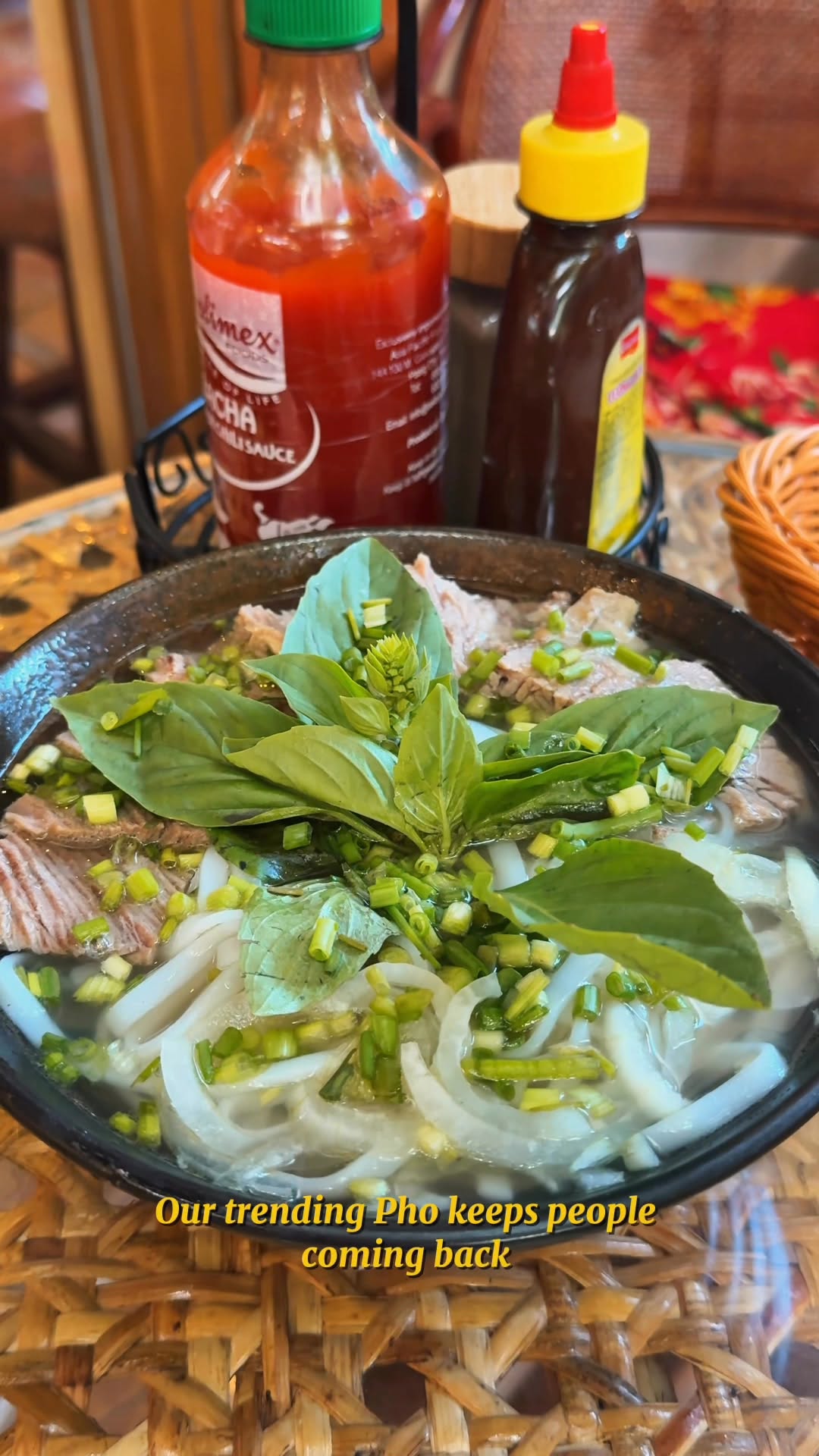 Phở Bò bowl with fresh herbs at MỘC Cafe