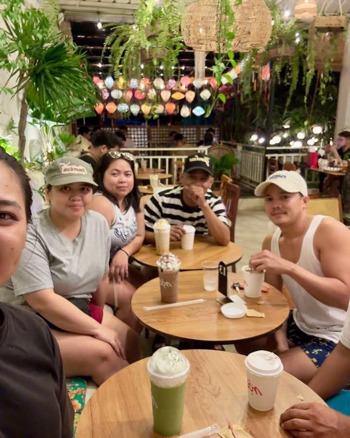 Group selfie inside MỘC Cafe with colorful lanterns