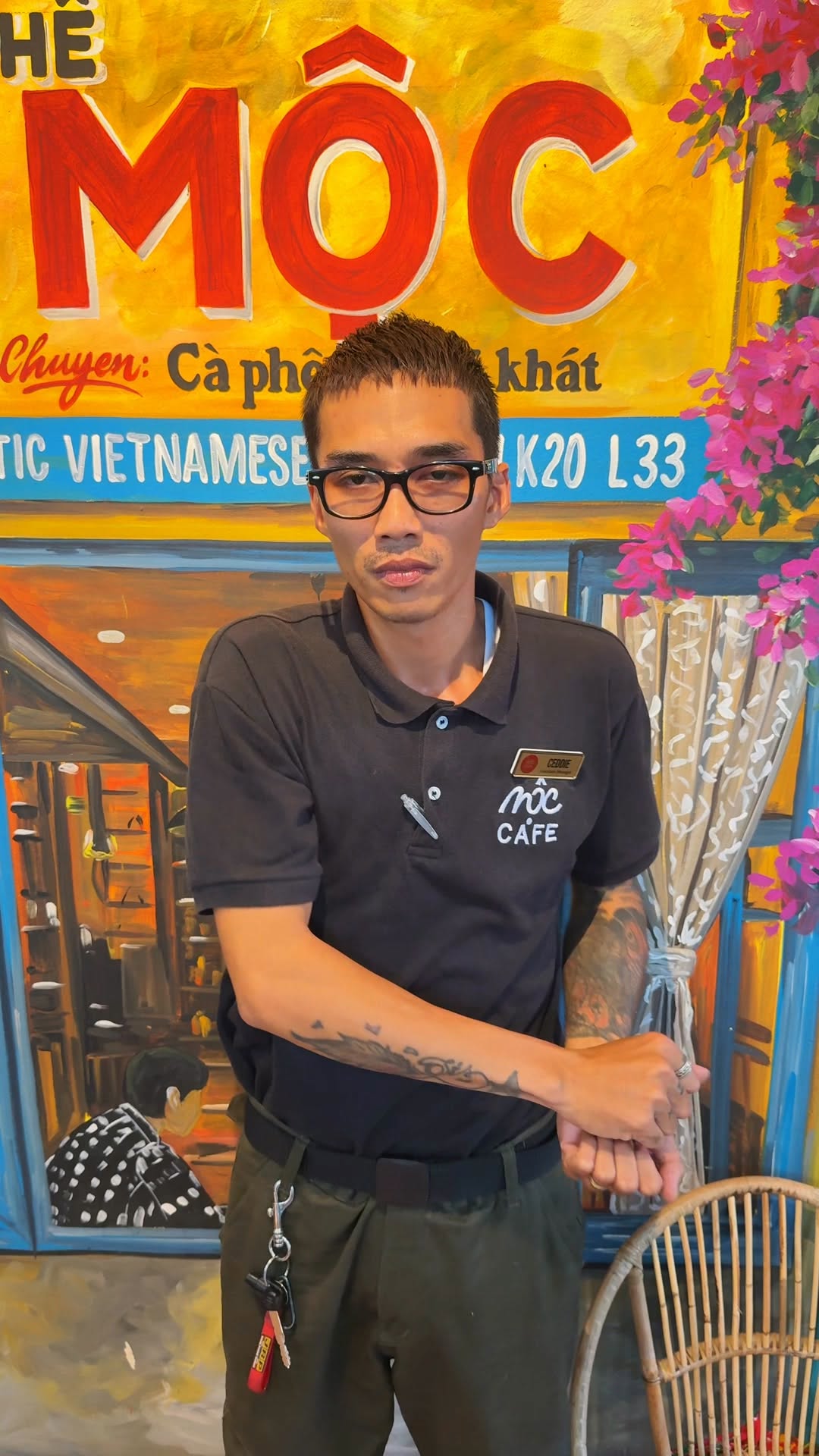 MỘC Cafe chef staff portrait in front of branded mural